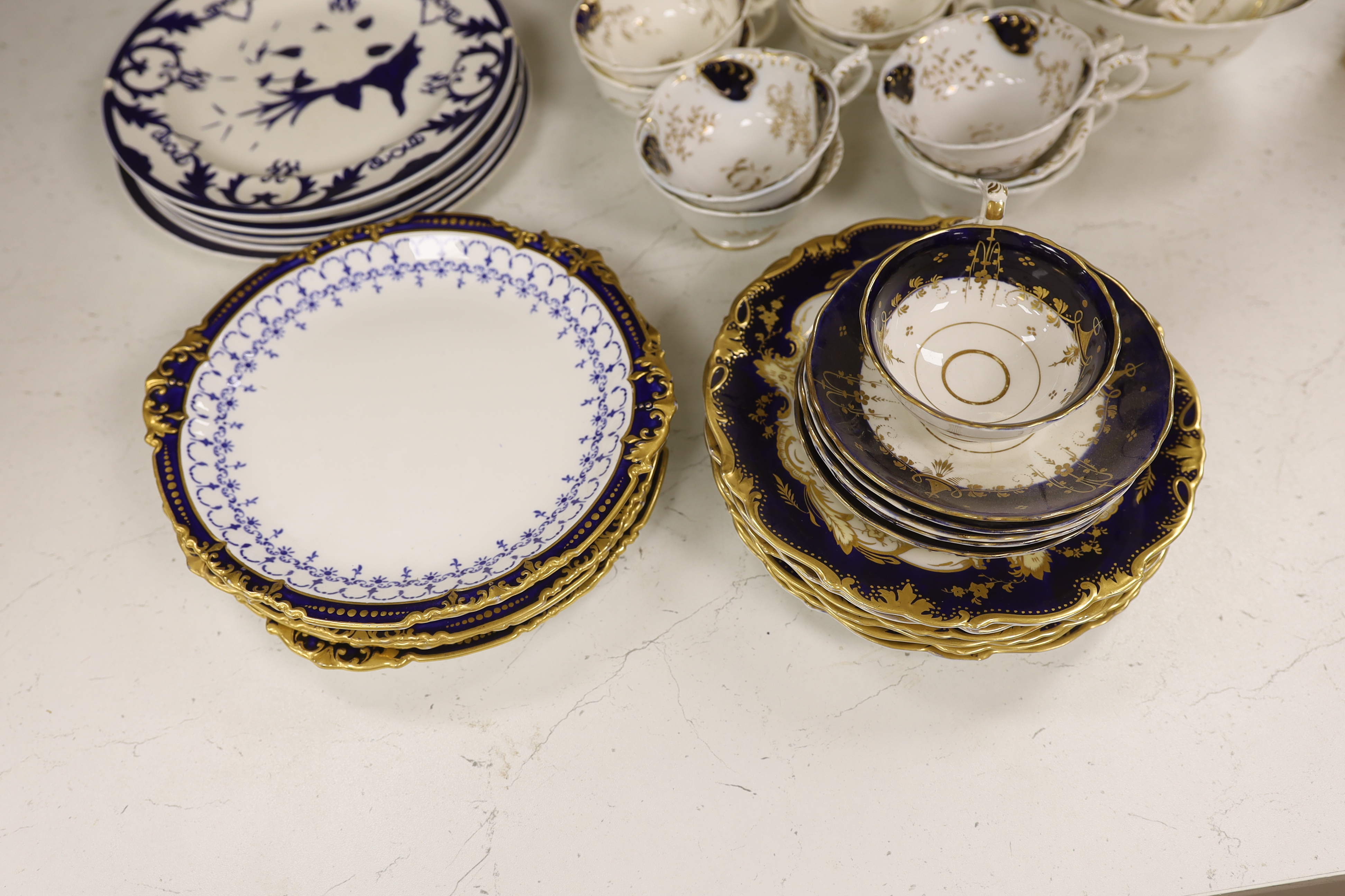 A Royal Crown Derby blue and gilt bordered part dessert service, together with a Victorian Staffordshire blue and gilt part tea service